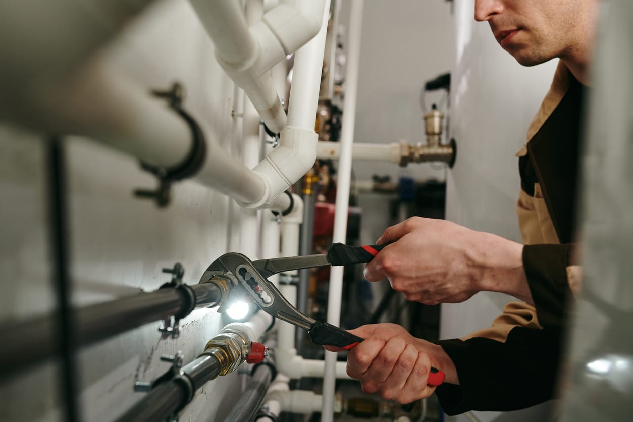 Plumbers maintaining commercial plumbing pipes in Cheltenham