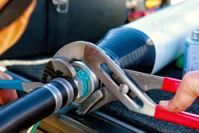 Technician tightening an industrial pipe connection in Cheltenham
