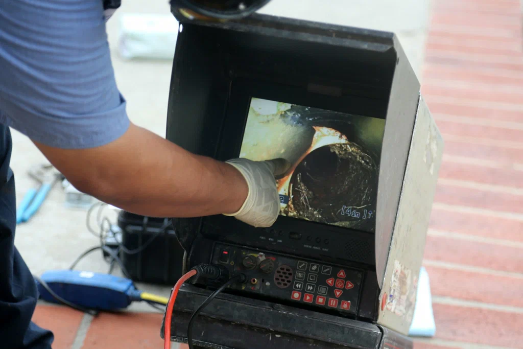 Technician viewing a drain inspection camera in Cheltenham