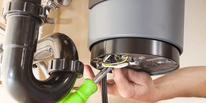 Technician repairing the heating element of a water heater in Cheltenham